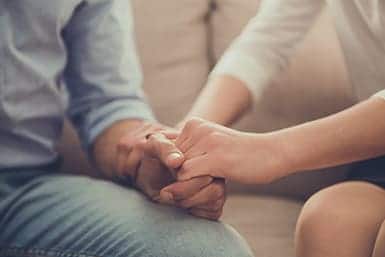 family embracing each other before hiring a baker act attorney