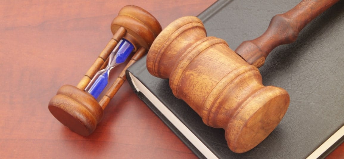 a wooden hour glass next to a gavel